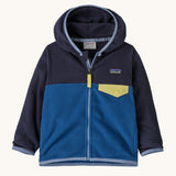 Patagonia little kids micro d snap t jacket in clement blue available at Babipur. A 100% recycled polyester soft fleece hooded jacket in dark navy and blue with light blue trim. Features a full length zip and small chest pocket with a yellow flap