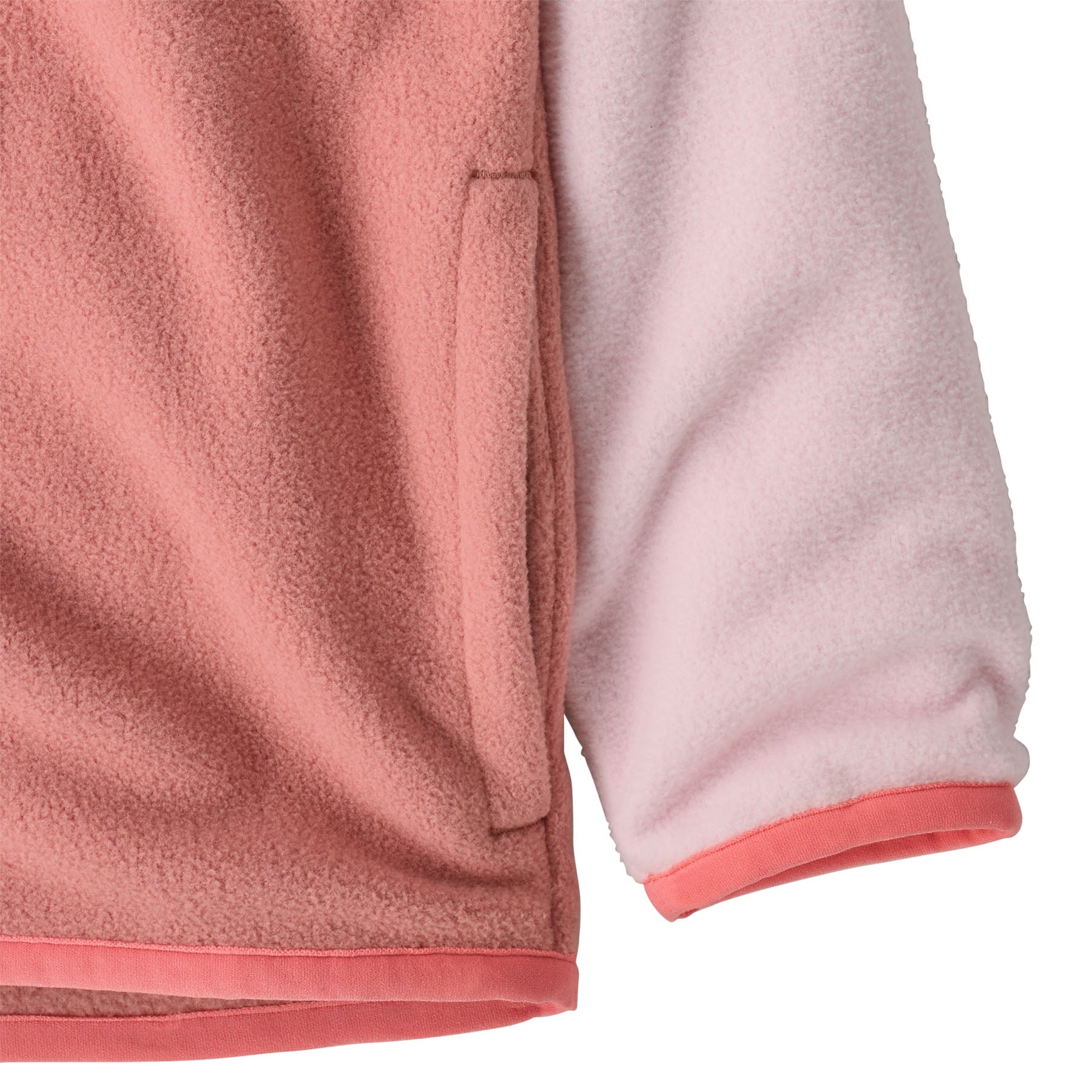 A close up of the Patagonia little kids micro d snap t jacket in moment pink available at Babipur showing the side pokcet and cuff detail