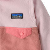 A close up of the Patagonia little kids micro d snap t jacket in moment pink available at Babipur showing the chest pocket detail
