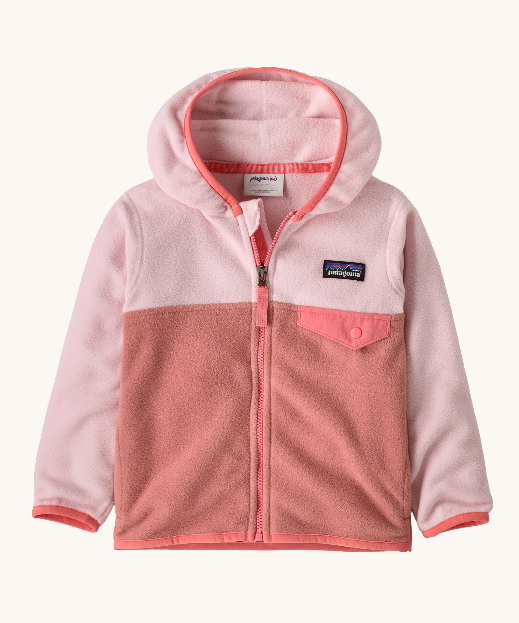 Patagonia little kids micro d snap t jacket in moment pink available at Babipur. A 100% recycled polyester soft fleece hooded jacket in light and dark pink with a matching trim. Features a full length zip and small chest pocket with a pink flap