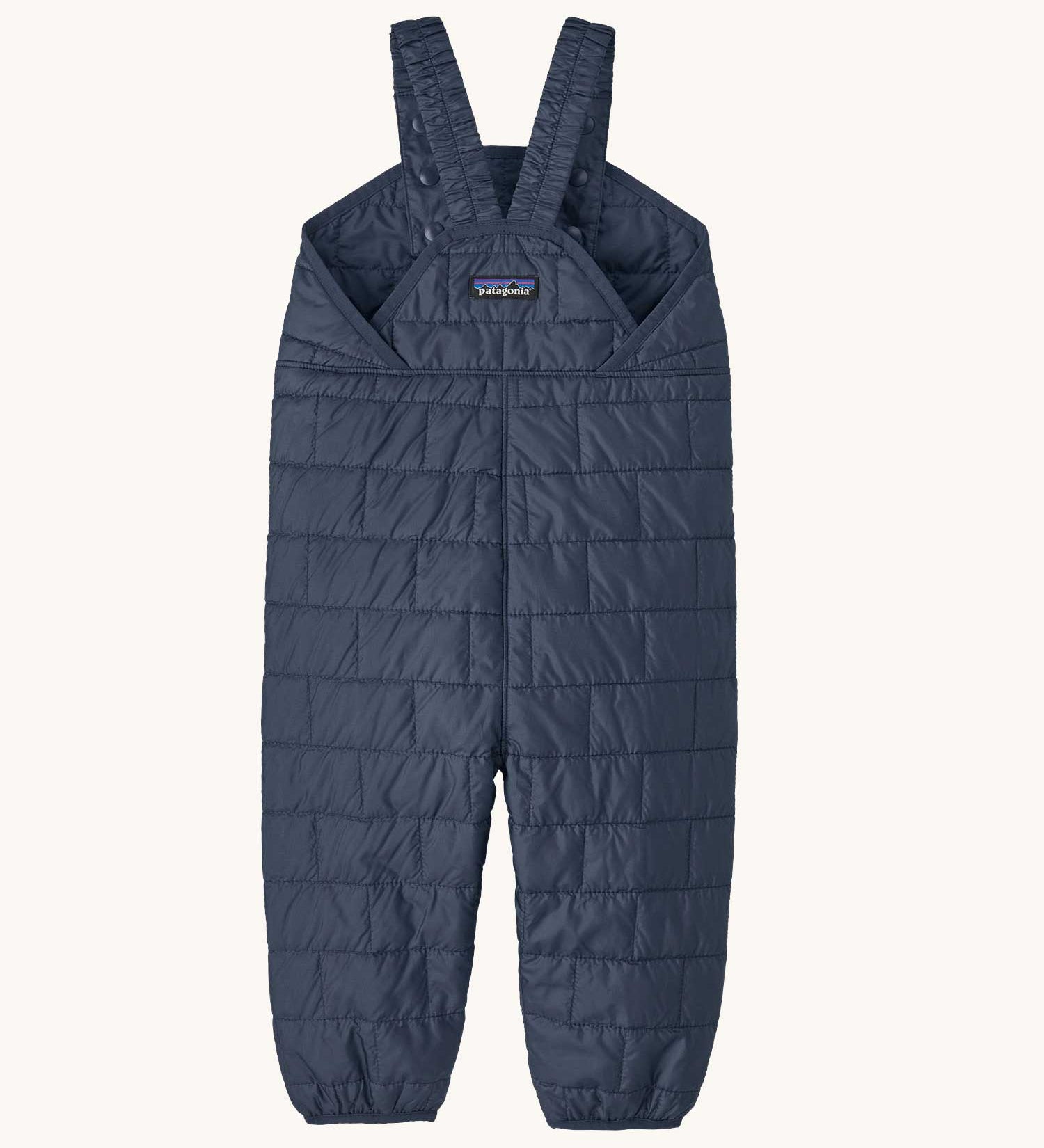 The back of the Patagonia kids nano puffer winter overalls in navy available at Babipur . Features popper fasteners on each shoulder strap for size adjustment. 