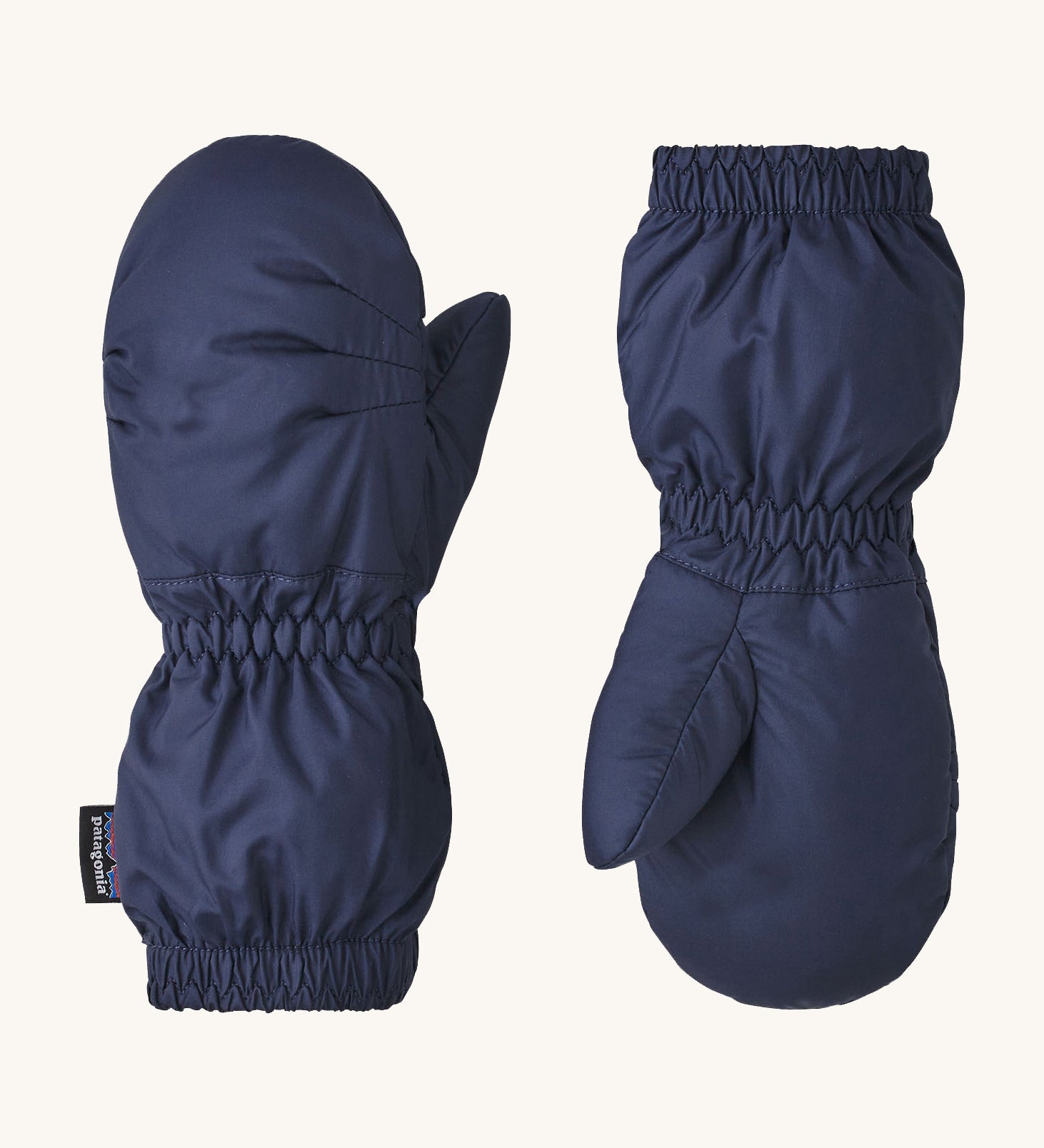 A pair of navy Patagonia mittens available at Babipur. Features elasticated cuffs for a snug fit