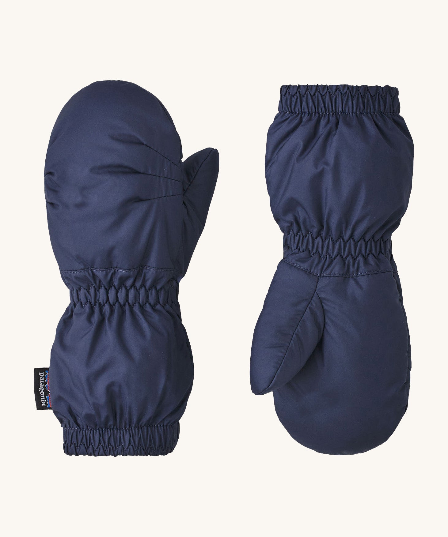 A pair of navy Patagonia mittens available at Babipur. Features elasticated cuffs for a snug fit
