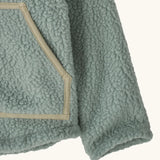 Patagonia little kids retro pile soft fleece hooded jacket in sage green showing close up of the front pocket with muted trim