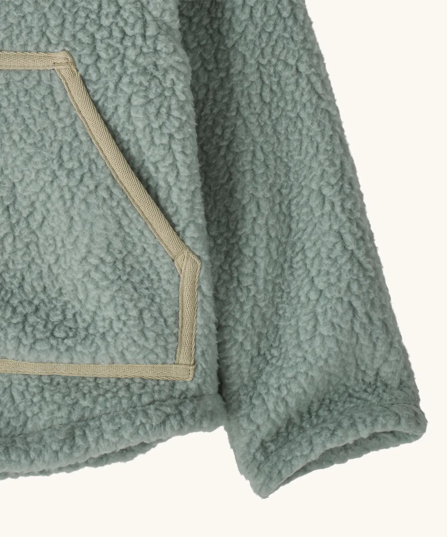 Patagonia little kids retro pile soft fleece hooded jacket in sage green showing close up of the front pocket with muted trim