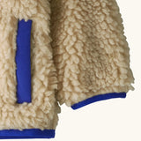 Patagonia little kids retro x pile fleece hooded jacket in beige showing coloured cuff and hem trim and side pocket