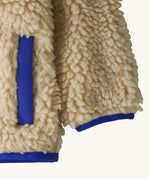 Patagonia little kids retro x pile fleece hooded jacket in beige showing coloured cuff and hem trim and side pocket