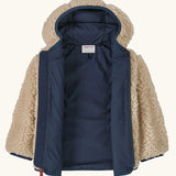 An open Patagonia little kids retro x pile windproof hooded fleece jacket in beige showing the navy inner liner