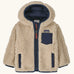 Patagonia little kids retro x pile windproof hooded fleece jacket in beige with a navy inner. Shows a full front zip, side and chest pockets
