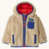 Patagonia little kids retro x hoody in dark natural available at Babipur. A 100% recycled polyester thick pile fleece hooded jacket in cream with blue trim Features a full length zip, 2 side pockets and a small chest pocket