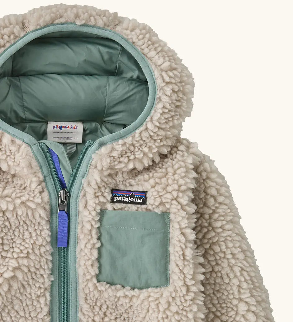 Patagonia little kids retro x pile windproof hooded fleece jacket in beige with a sage green inner showing close up of chest pocket and front zip
