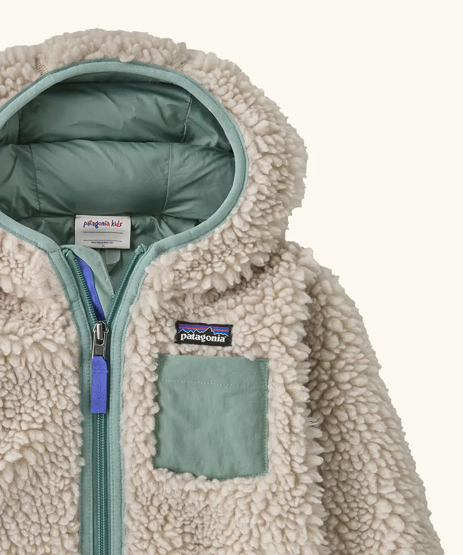 Patagonia little kids retro x pile windproof hooded fleece jacket in beige with a sage green inner showing close up of chest pocket and front zip