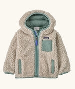 Patagonia little kids retro x pile windproof hooded fleece jacket in beige with a sage green inner. Shows a full front zip, side and chest pockets