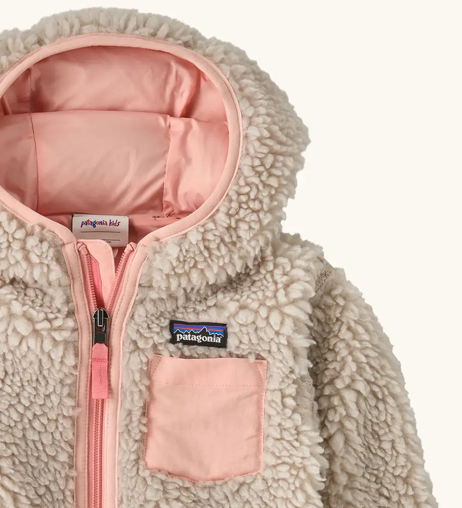 Patagonia little kids retro x pile windproof hooded fleece jacket in beige with a pink inner showing a close up of the pink chest pocket and front zip detail