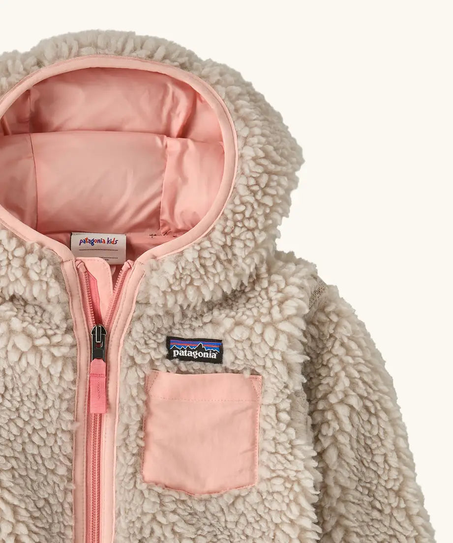 Patagonia little kids retro x pile windproof hooded fleece jacket in beige with a pink inner showing a close up of the pink chest pocket and front zip detail