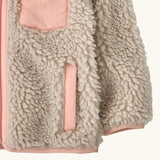 Patagonia little kids retro x pile windproof hooded fleece jacket in beige with a pink inner showing a close up the side pocket and cuff with pink trim