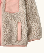 Patagonia little kids retro x pile windproof hooded fleece jacket in beige with a pink inner showing a close up the side pocket and cuff with pink trim