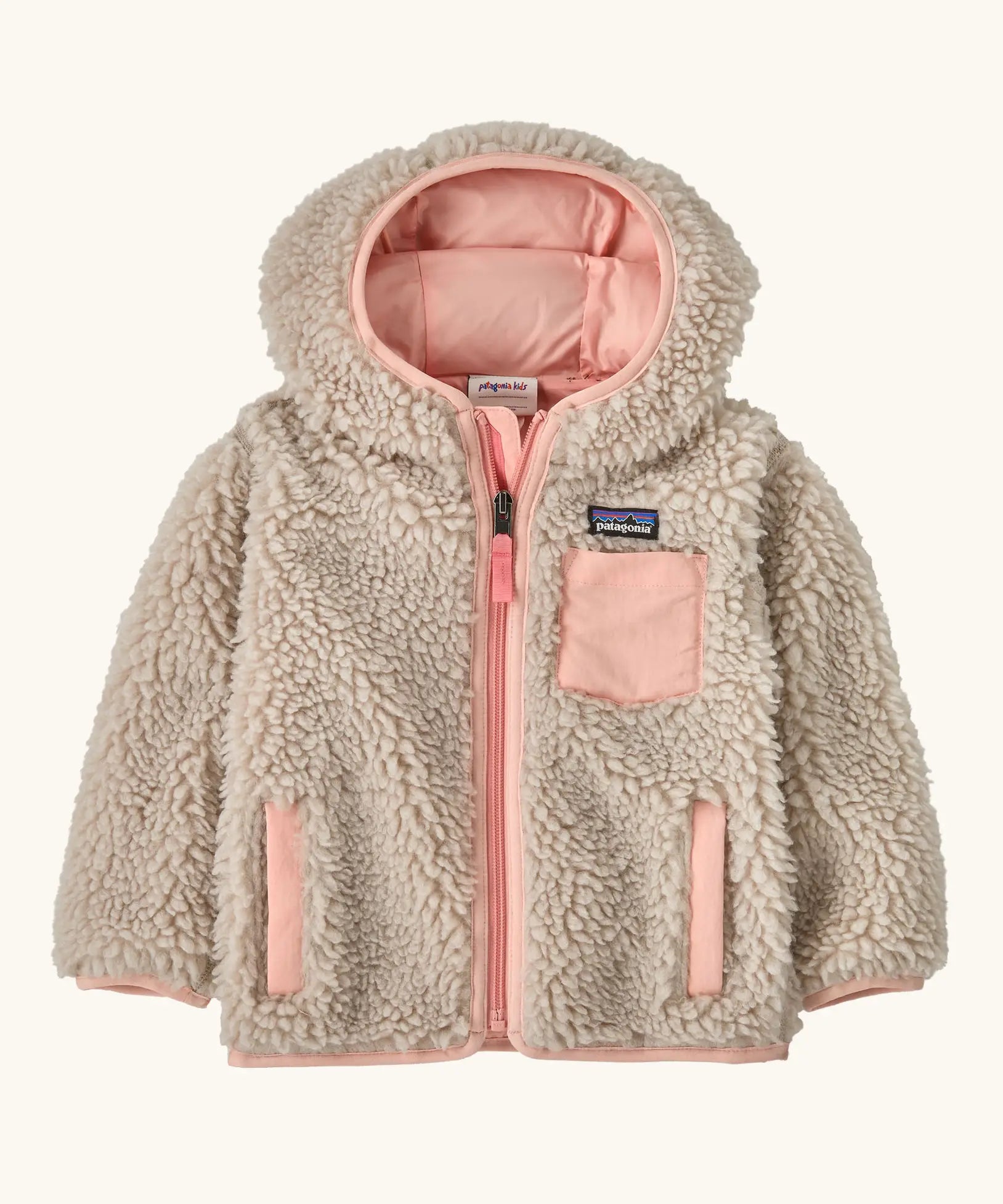 Patagonia little kids retro x pile windproof hooded fleece jacket in beige with a pink inner. Shows a full front zip, side and chest pockets
