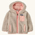 Patagonia little kids retro x pile windproof hooded fleece jacket in beige with a pink inner. Shows a full front zip, side and chest pockets