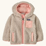 Patagonia little kids retro x pile windproof hooded fleece jacket in beige with a pink inner. Shows a full front zip, side and chest pockets