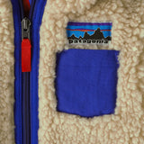Patagonia little kids retro x pile fleece hooded jacket in beige showing close up of chest pocket and front zip
