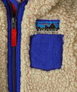 Patagonia little kids retro x pile fleece hooded jacket in beige showing close up of chest pocket and front zip