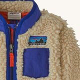 Patagonia little kids retro x pile fleece jacket in neutral showing stand up collar and small chest pocket