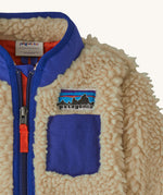 Patagonia little kids retro x pile fleece jacket in neutral showing stand up collar and small chest pocket