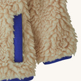 Patagonia little kids retro x pile fleece jacket in neutral showing close up of coloured hem, cuff and side pocket