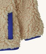 Patagonia little kids retro x pile fleece jacket in neutral showing close up of coloured hem, cuff and side pocket