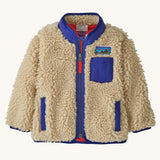 Patagonia little kids retro x jacket in dark natural available at Babipur. A 100% recycled polyester and pile fleece jacket in cream with dark blue trim. Features a full length zip, 2 side pockets and a chest pocket