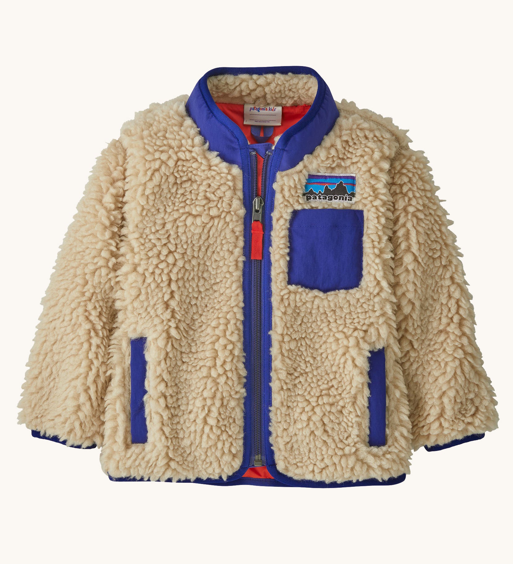 Patagonia little kids retro x jacket in dark natural available at Babipur. A 100% recycled polyester and pile fleece jacket in cream with dark blue trim. Features a full length zip, 2 side pockets and a chest pocket