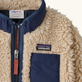Patagonia little kids retro x pile fleece jacket in neutral showing a close up of the navy turned up collar and chest pocket