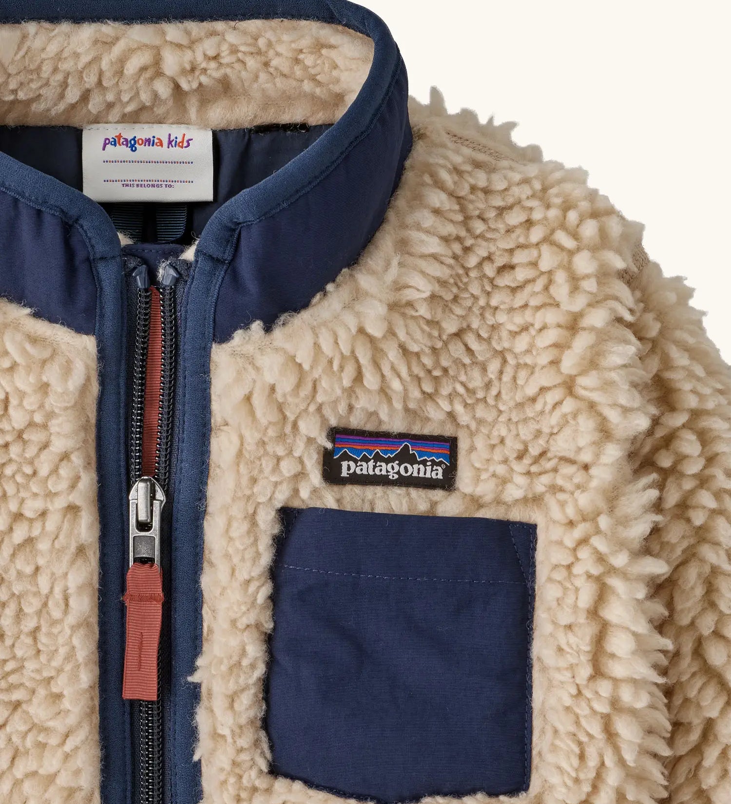 Patagonia little kids retro x pile fleece jacket in neutral showing a close up of the navy turned up collar and chest pocket