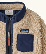 Patagonia little kids retro x pile fleece jacket in neutral showing a close up of the navy turned up collar and chest pocket