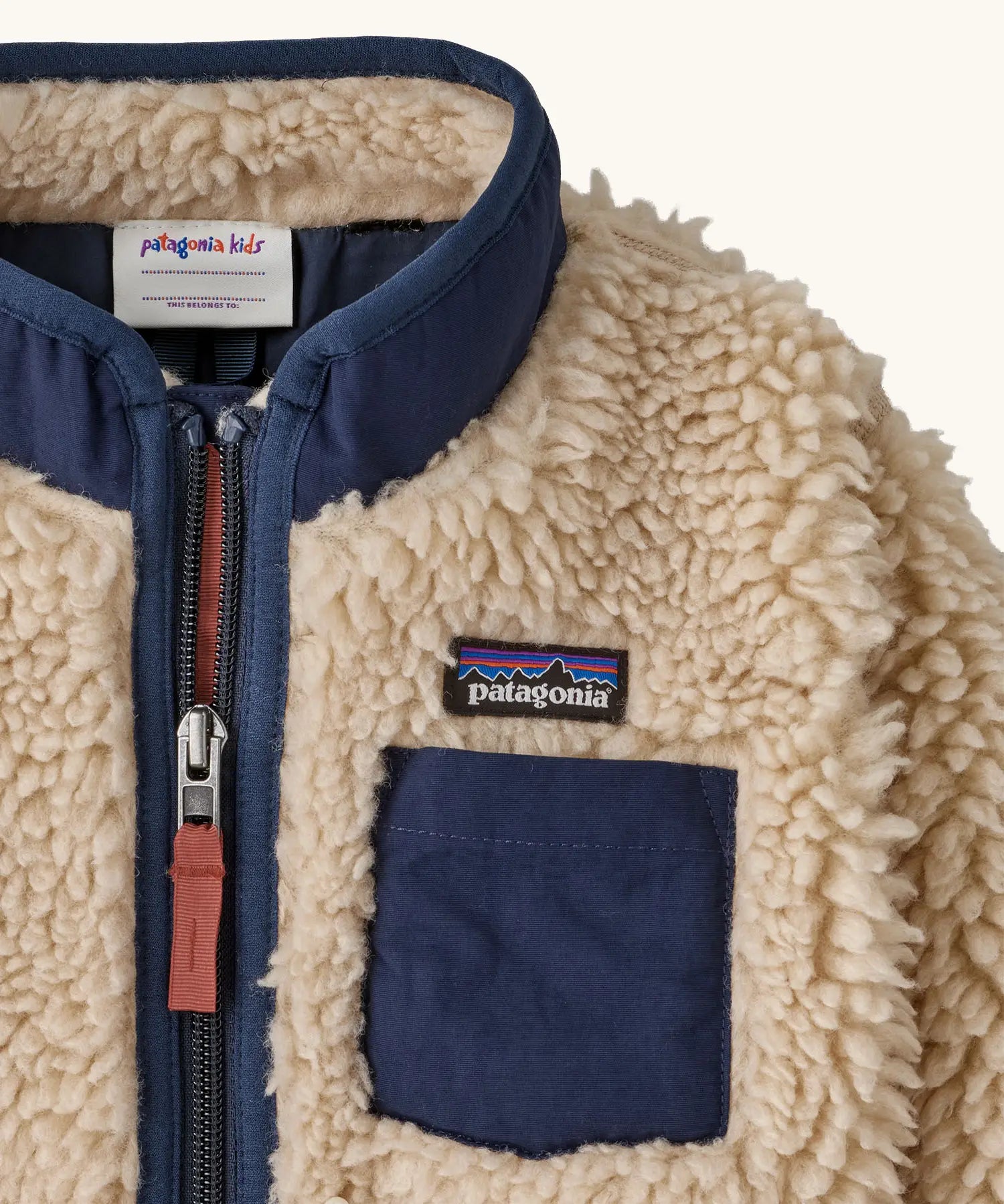 Patagonia little kids retro x pile fleece jacket in neutral showing a close up of the navy turned up collar and chest pocket