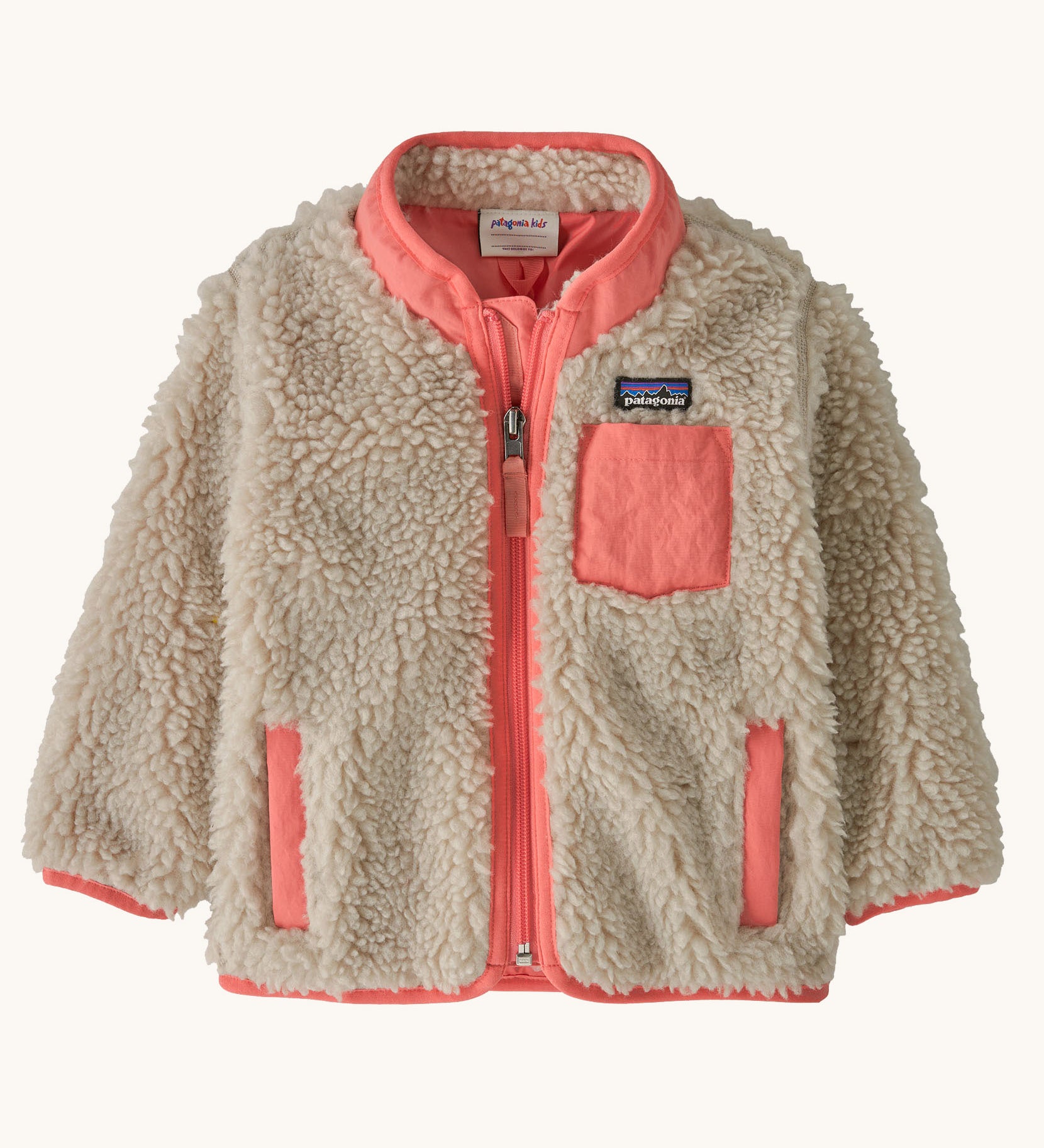 Patagonia little kids retro x jacket in dark natural/ sparkle pink available at Babipur. A 100% recycled polyester and pile fleece jacket in cream with pink  trim. Features a full length zip, 2 side pockets and a chest pocket