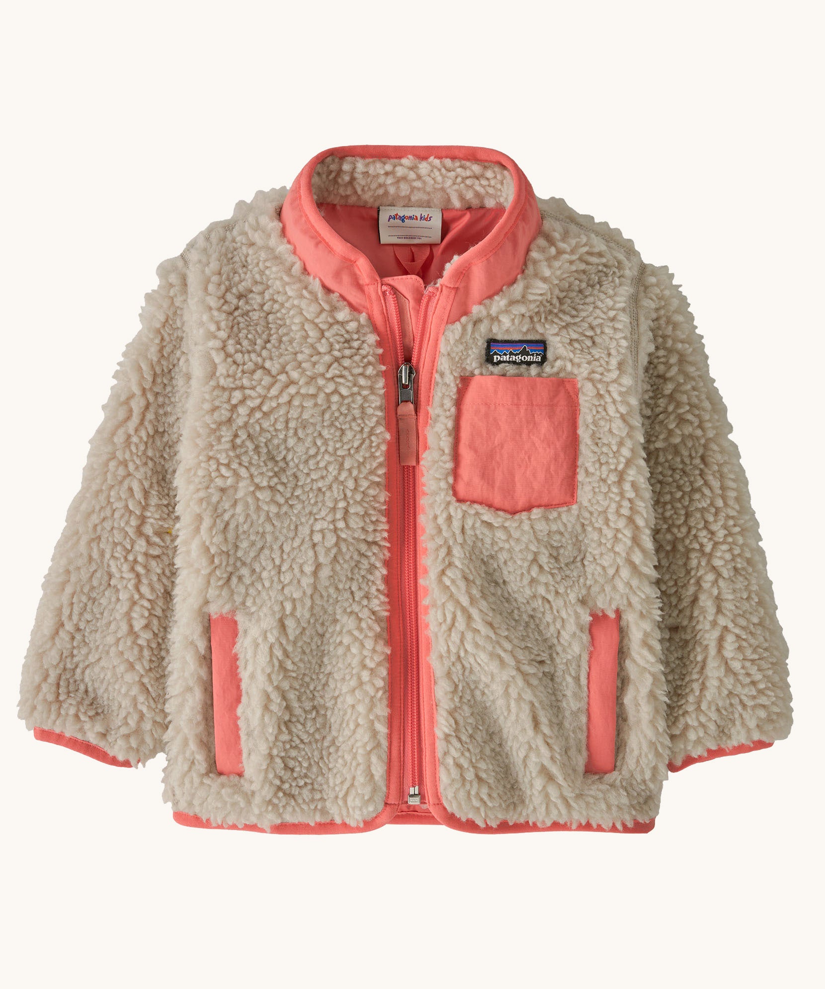 Patagonia little kids retro x jacket in dark natural/ sparkle pink available at Babipur. A 100% recycled polyester and pile fleece jacket in cream with pink  trim. Features a full length zip, 2 side pockets and a chest pocket