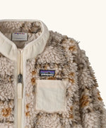 Patagonia little kids retro x pile fleece jacket in warm brown pattern showing a close up of the neutral turn up collar and chest pocket