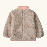 Back of Patagonia little kids retro x pile fleece jacket in neutral with a pink turn up collar 