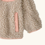 Patagonia little kids retro x pile fleece jacket in neutral showing close up of the side pocket and cuff with pink trim