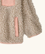 Patagonia little kids retro x pile fleece jacket in neutral showing close up of the side pocket and cuff with pink trim