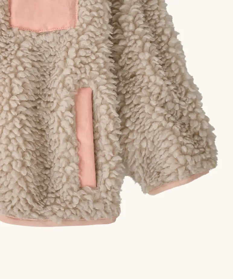 Patagonia little kids retro x pile fleece jacket in neutral showing close up of the side pocket and cuff with pink trim