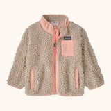 Patagonia little kids retro x pile fleece jacket in neutral with a pink trim. Shows a full front zip, side and chest pockets