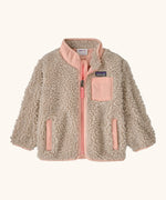 Patagonia little kids retro x pile fleece jacket in neutral with a pink trim. Shows a full front zip, side and chest pockets