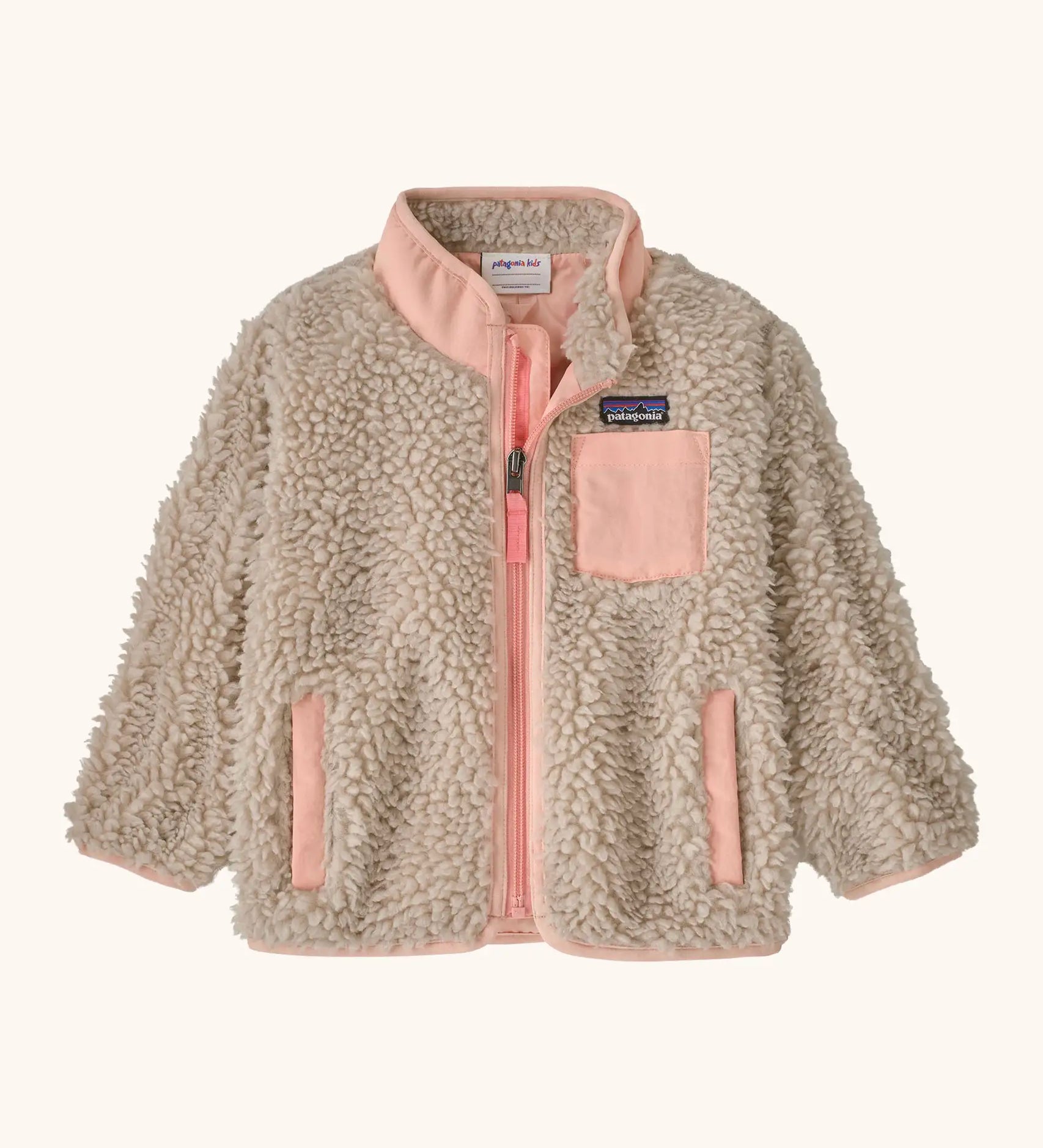 Patagonia little kids retro x pile fleece jacket in neutral with a pink trim. Shows a full front zip, side and chest pockets