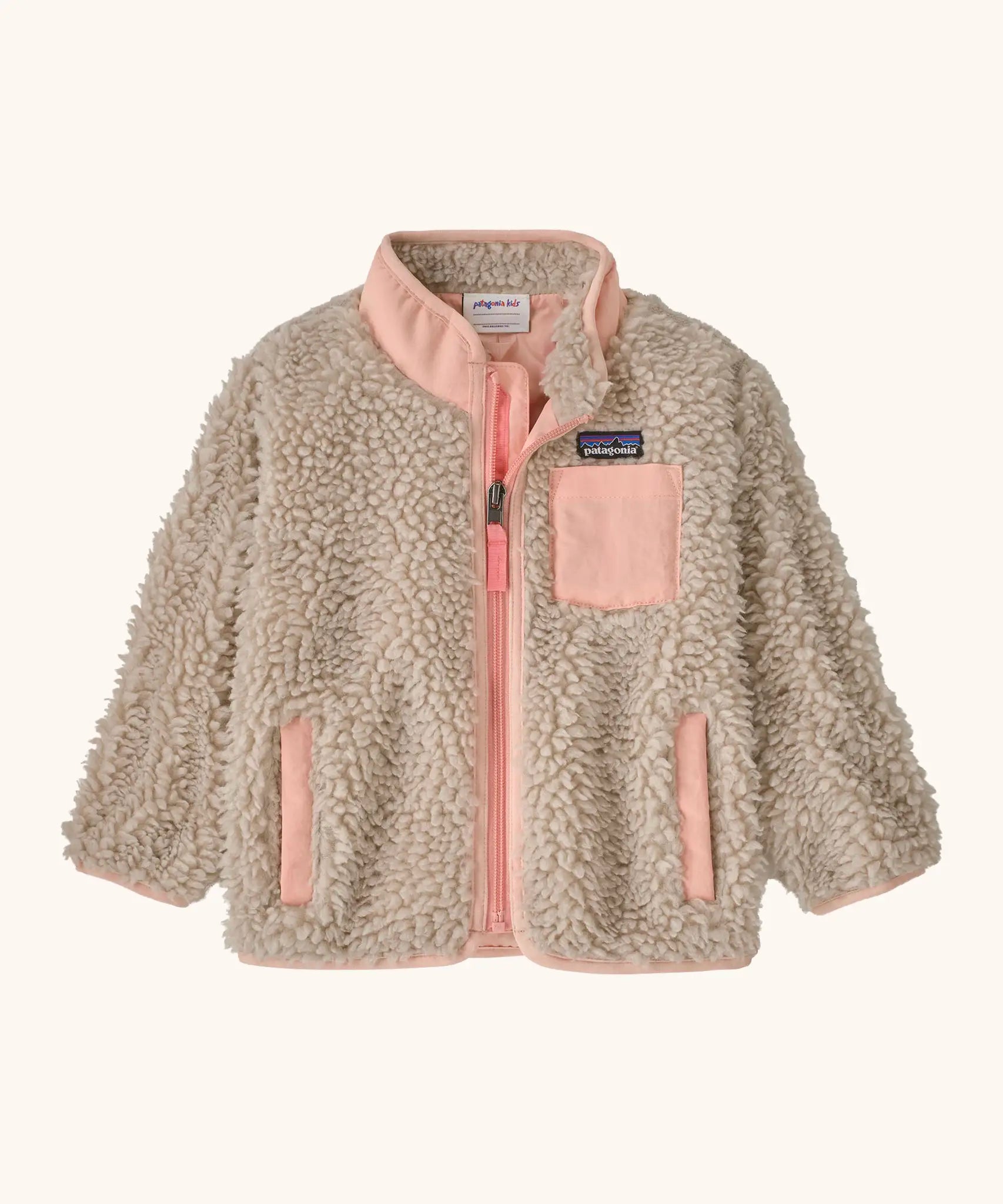 Patagonia little kids retro x pile fleece jacket in neutral with a pink trim. Shows a full front zip, side and chest pockets