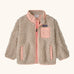 Patagonia little kids retro x pile fleece jacket in neutral with a pink trim. Shows a full front zip, side and chest pockets