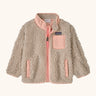 Patagonia little kids retro x pile fleece jacket in neutral with a pink trim. Shows a full front zip, side and chest pockets
