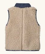 Back of Patagonia 100% recycled polyester little kids retro x high pile fleece vest in beige with a navy turned up collar 